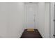 Bright foyer with dark wood flooring, a white front door, and a welcome mat at 154 Alamosa Pl, Cary, NC 27519