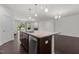 Open kitchen featuring large island with stainless steel dishwasher, granite countertops and pendant lighting at 154 Alamosa Pl, Cary, NC 27519