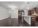 Spacious kitchen featuring dark wood cabinets, stainless steel appliances, and a granite-topped island at 154 Alamosa Pl, Cary, NC 27519