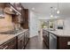 Modern kitchen featuring stainless steel appliances, granite countertops and dark wood cabinetry at 154 Alamosa Pl, Cary, NC 27519