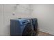 Laundry room with modern Samsung washer and dryer plus storage shelves at 154 Alamosa Pl, Cary, NC 27519