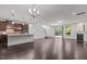 Open-concept living space with hardwood floors, a fireplace, and sliding glass doors to the patio at 154 Alamosa Pl, Cary, NC 27519