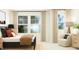 Bedroom features a bed, side chair, and bright windows with natural light at 1543 Crescent Townes Way, Raleigh, NC 27604