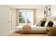 Bright bedroom featuring a bed, windows, and a stylish bench at 1543 Crescent Townes Way, Raleigh, NC 27604