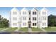 Charming townhome with a modern facade, complemented by a well-manicured lawn and landscaped pathway at 1543 Crescent Townes Way, Raleigh, NC 27604