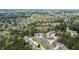 An aerial view of the house sitting in a wooded area near the cul-de-sac and other houses at 1808 W Cotton Gin Dr, Clayton, NC 27527