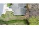 A high angle aerial view of the backyard featuring a patio, green space and lots of trees at 1808 W Cotton Gin Dr, Clayton, NC 27527