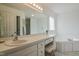Clean bathroom featuring a soaking tub, vanity with great storage, and great natural light at 1808 W Cotton Gin Dr, Clayton, NC 27527