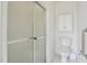 Bathroom featuring a frosted glass enclosed shower, toilet, and storage at 1808 W Cotton Gin Dr, Clayton, NC 27527