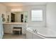 Relaxing bathroom featuring a soaking tub, vanity with great storage, and great natural light at 1808 W Cotton Gin Dr, Clayton, NC 27527