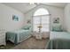 Welcoming bedroom features two beds, a neutral color scheme, and a large arched window at 1808 W Cotton Gin Dr, Clayton, NC 27527
