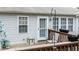 View of the deck with chairs and a small table with a backyard view at 1808 W Cotton Gin Dr, Clayton, NC 27527