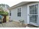 View of the side of the house with windows and an exterior door at 1808 W Cotton Gin Dr, Clayton, NC 27527