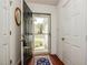 Home entryway featuring a black front door, wood floors, and a glimpse of the home's exterior at 1808 W Cotton Gin Dr, Clayton, NC 27527