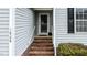 Charming front porch with brick steps, screen door, and light-gray siding on this lovely home at 1808 W Cotton Gin Dr, Clayton, NC 27527