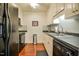 Functional kitchen with white cabinets, dark appliances, and tile backsplash at 1808 W Cotton Gin Dr, Clayton, NC 27527