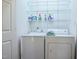 Convenient laundry room featuring a washer, a dryer, and shelving for storage at 1808 W Cotton Gin Dr, Clayton, NC 27527