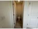 This bathroom has a white toilet with wooden floors and a white door at 190 Chestnut Oak Ln, Lillington, NC 27546