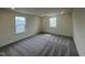This bedroom has gray carpet, white walls, and two windows at 190 Chestnut Oak Ln, Lillington, NC 27546