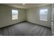 This bedroom has gray carpet, white walls, and a window at 190 Chestnut Oak Ln, Lillington, NC 27546