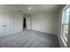 This bedroom has gray carpet, white walls, a window, and a closet at 190 Chestnut Oak Ln, Lillington, NC 27546