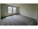 Spacious bedroom featuring plush carpet and natural light from large windows at 190 Chestnut Oak Ln, Lillington, NC 27546