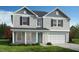 Charming two-story home with a welcoming front porch and a two-car garage at 190 Chestnut Oak Ln, Lillington, NC 27546