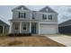 Charming two-story home featuring a welcoming front porch and two-car garage at 190 Chestnut Oak Ln, Lillington, NC 27546