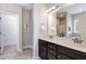 Bathroom showcasing double vanity sinks, marble countertops, and framed mirror at 191 W Cultivator Way, Clayton, NC 27520