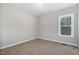 Neutral bedroom showcasing carpeted floors and a single window at 191 W Cultivator Way, Clayton, NC 27520