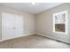 Bedroom featuring a double door closet and a window with a view of the backyard at 191 W Cultivator Way, Clayton, NC 27520