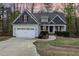 Charming single-Gathering home features a two-car garage, mature trees, and manicured lawn at 191 W Cultivator Way, Clayton, NC 27520