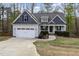 Charming two-story home with a gray shingled roof, a well-manicured lawn, and a two-car garage at 191 W Cultivator Way, Clayton, NC 27520