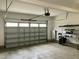 Spacious garage with an automatic door and a Tesla Powerwall at 191 W Cultivator Way, Clayton, NC 27520