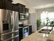Modern kitchen with stainless steel appliances, granite countertops, and ample cabinet space at 191 W Cultivator Way, Clayton, NC 27520