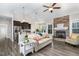 Open-concept living room with a fireplace, ceiling fan, and access to the kitchen at 191 W Cultivator Way, Clayton, NC 27520