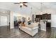 Open-concept living room flows into dining area, with kitchen bar and view to backyard at 191 W Cultivator Way, Clayton, NC 27520