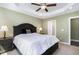 Main bedroom featuring a tray ceiling, ceiling fan, and en suite bathroom at 191 W Cultivator Way, Clayton, NC 27520