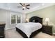 Bedroom with tray ceiling, neutral walls, carpeted floor, and large window at 191 W Cultivator Way, Clayton, NC 27520