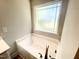 Soaking tub with a frosted window and chrome fixtures at 193 Falls Of The Cape Dr, Lillington, NC 27546