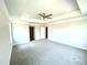 Spacious primary bedroom featuring neutral paint, tray ceilings, and a ceiling fan at 193 Falls Of The Cape Dr, Lillington, NC 27546