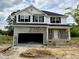 New two story home featuring white siding, black shutters, stone accents and an attached two car garage at 193 Falls Of The Cape Dr, Lillington, NC 27546