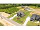 Aerial shot of a modern home design with a large manicured yard and a long white driveway at 20 Serenity Woods Trl, Franklinton, NC 27525