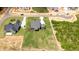 An aerial view showcasing the home's layout, detached garage, and spacious yard in a new development at 20 Serenity Woods Trl, Franklinton, NC 27525