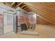 Unfinished attic space, featuring exposed beams, homeguard insulation, and an entrance at 20 Serenity Woods Trl, Franklinton, NC 27525