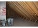 Unfinished attic space with exposed wooden beams and a floor ready for customization at 20 Serenity Woods Trl, Franklinton, NC 27525