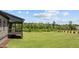 A picturesque view of the home's expansive green lawn and lush, surrounding treeline at 20 Serenity Woods Trl, Franklinton, NC 27525