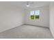 Light filled bedroom with gray carpet and ceiling fan features a large window offering lots of natural light at 20 Serenity Woods Trl, Franklinton, NC 27525