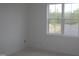 Bright bedroom featuring a large window offering ample natural light and serene views of the outdoors at 20 Serenity Woods Trl, Franklinton, NC 27525