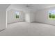 Spacious bedroom featuring a vaulted ceiling, ceiling fan, plush carpet, and natural light from two windows at 20 Serenity Woods Trl, Franklinton, NC 27525